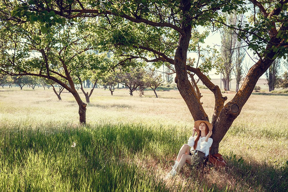 young girl in a straw hat travels green meadows Nature Connection & Mental Health | Benefits of Green Spaces